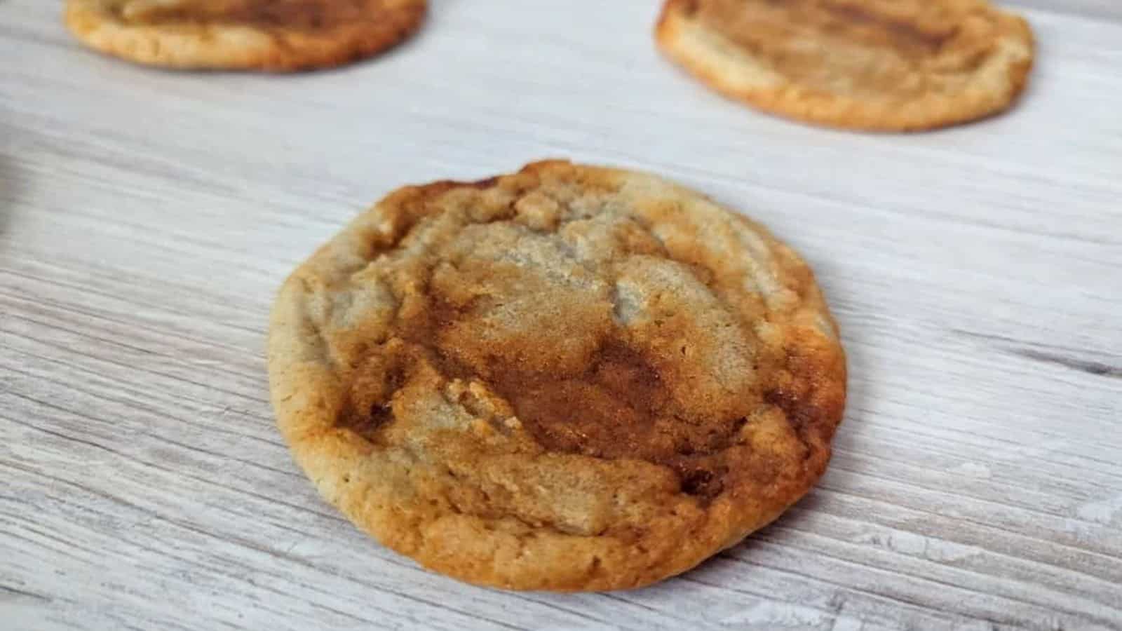 Image shows a wooden table with gochujang caramel cookies on it.