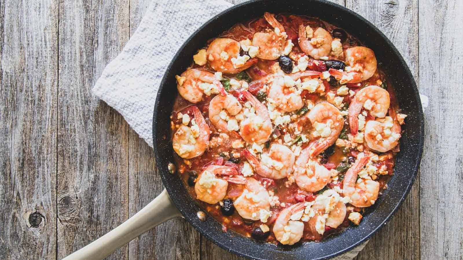 Shrimp skillet dinner with kalamata olives, tomatoes and feta.