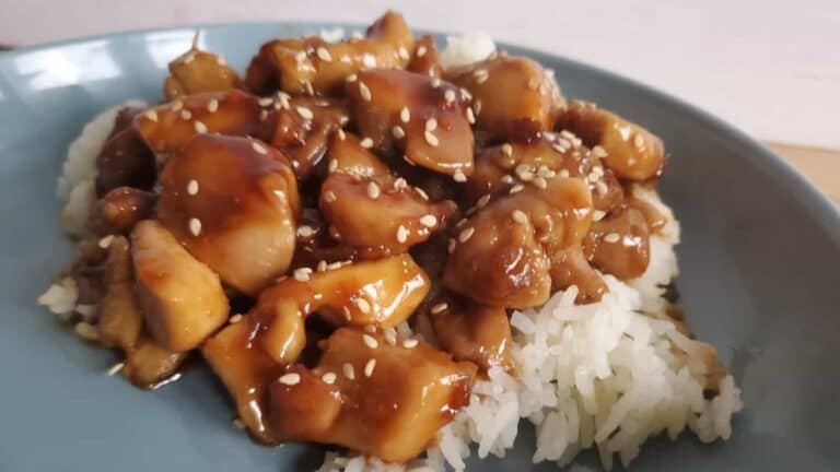 Image shows Honey glazed chicken on a blue plate.