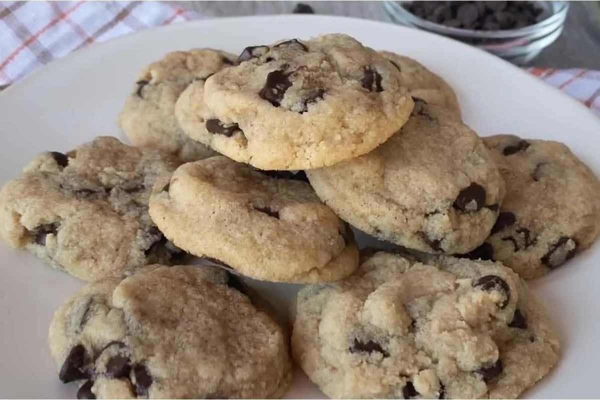 Chocolate chip cookies on a white plate.