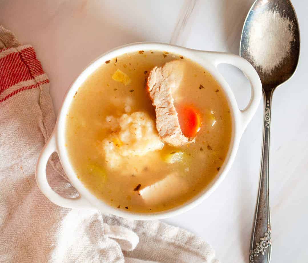 A bowl of turkey dumpling soup.