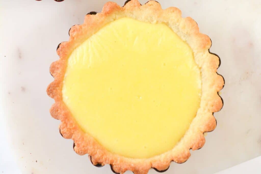 Lemon tart on a white surface.