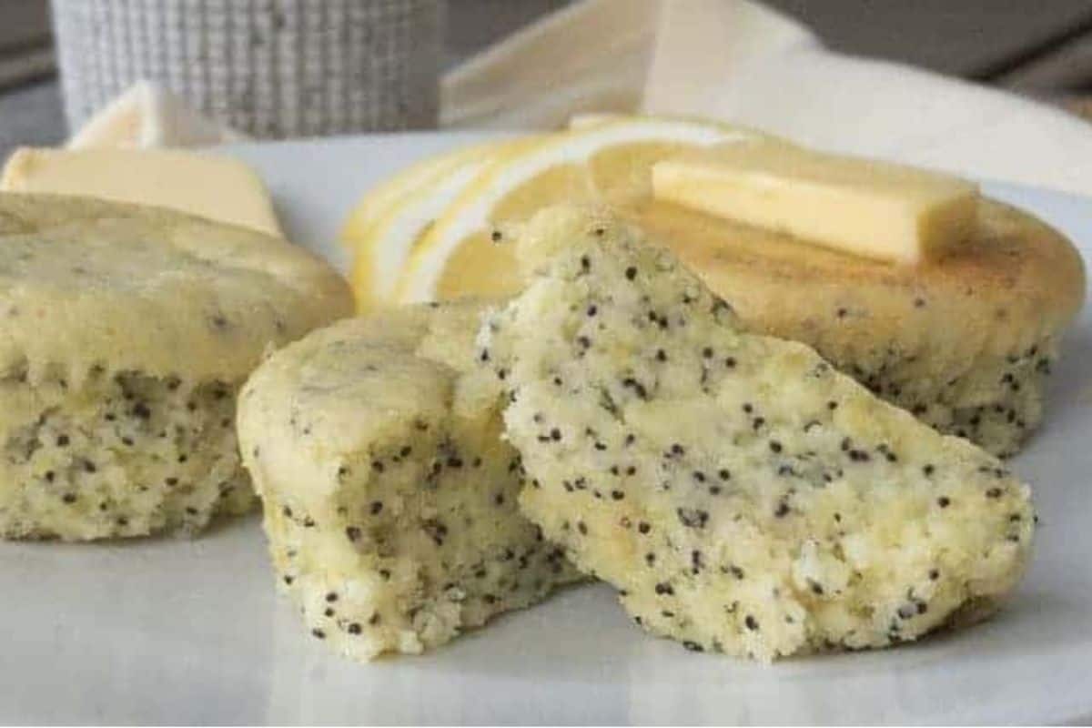 Poppy seed muffins on a plate.