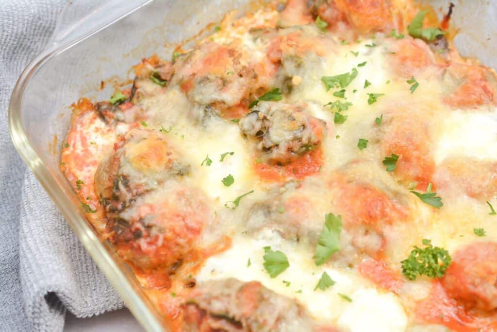 Meatballs in tomato sauce in a casserole dish.