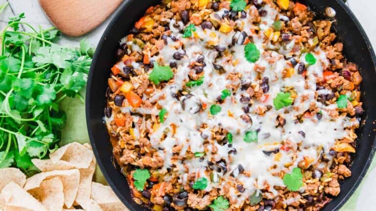 Mexican stir fry in a skillet with tortilla chips.