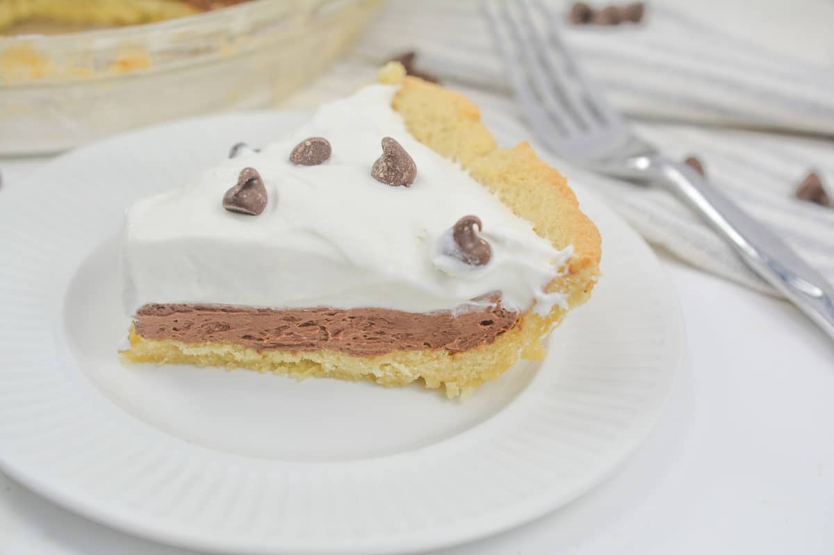 A slice of chocolate ice cream pie on a white plate.