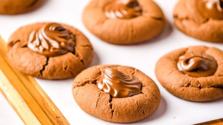 Chocolate cookies on a wooden cutting board.