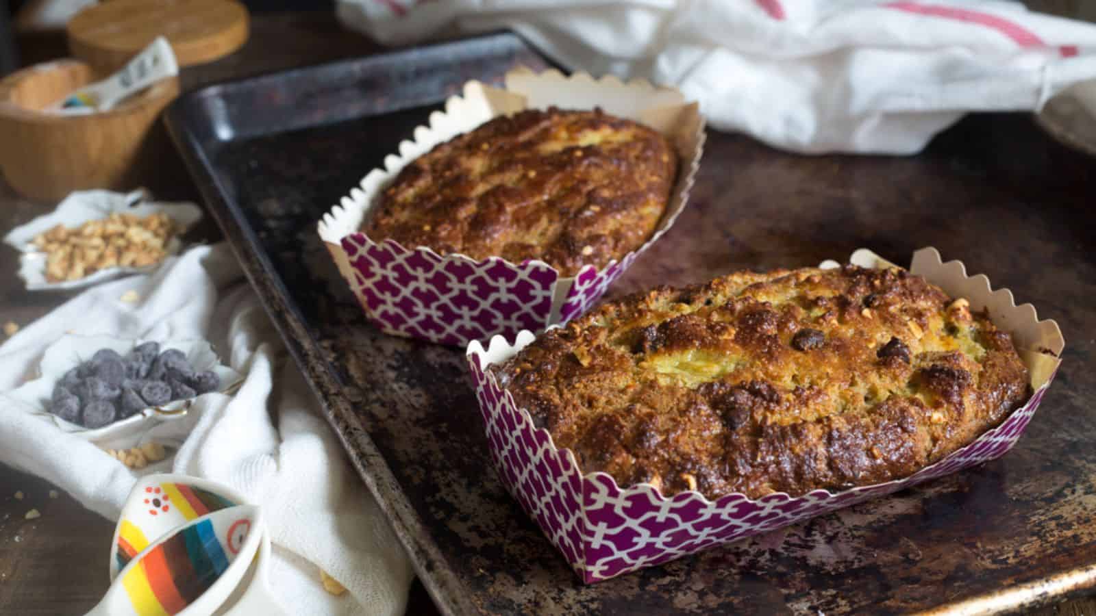 Two loaves of banana bread on a baking tray.