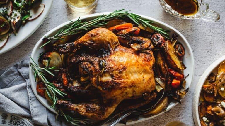 Roasted chicken and vegetables on a table.