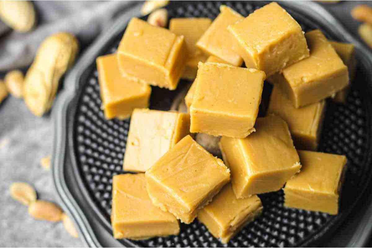 Peanut butter fudge on a black plate.