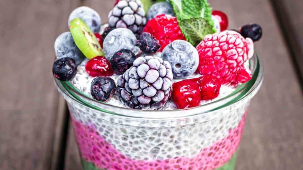 Chia pudding in a jar with berries and mint.