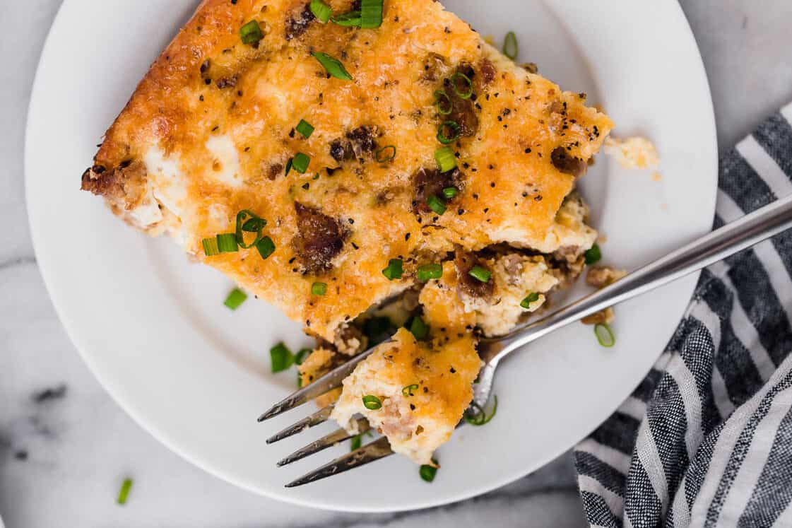 Sausage breakfast casserole on a plate with a fork.