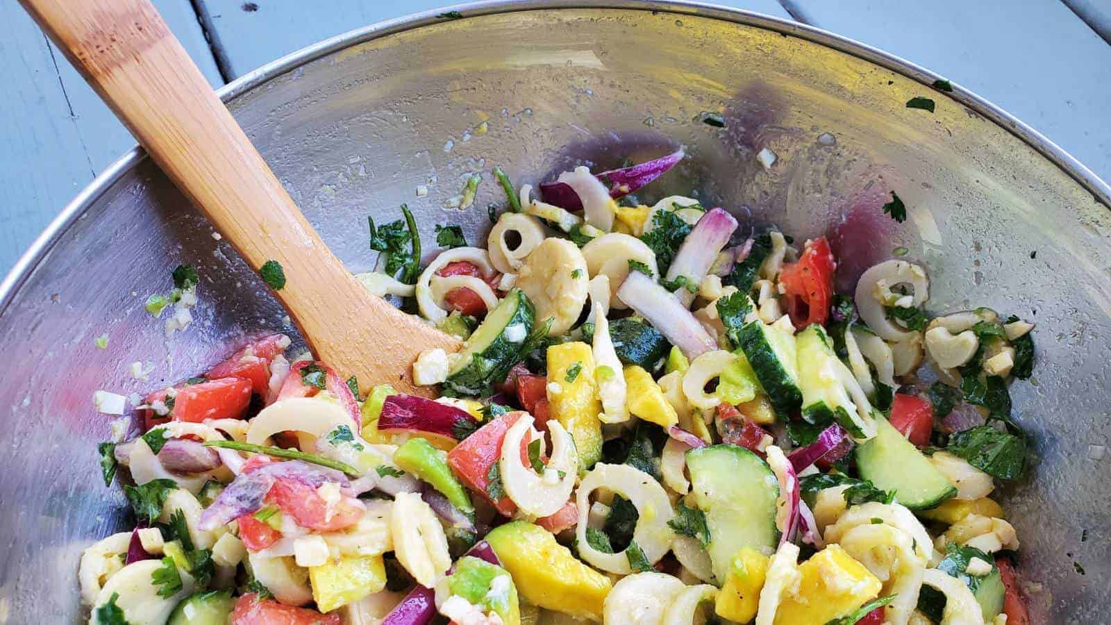 Silver bowl with a veggie filled hearts of palm salad.