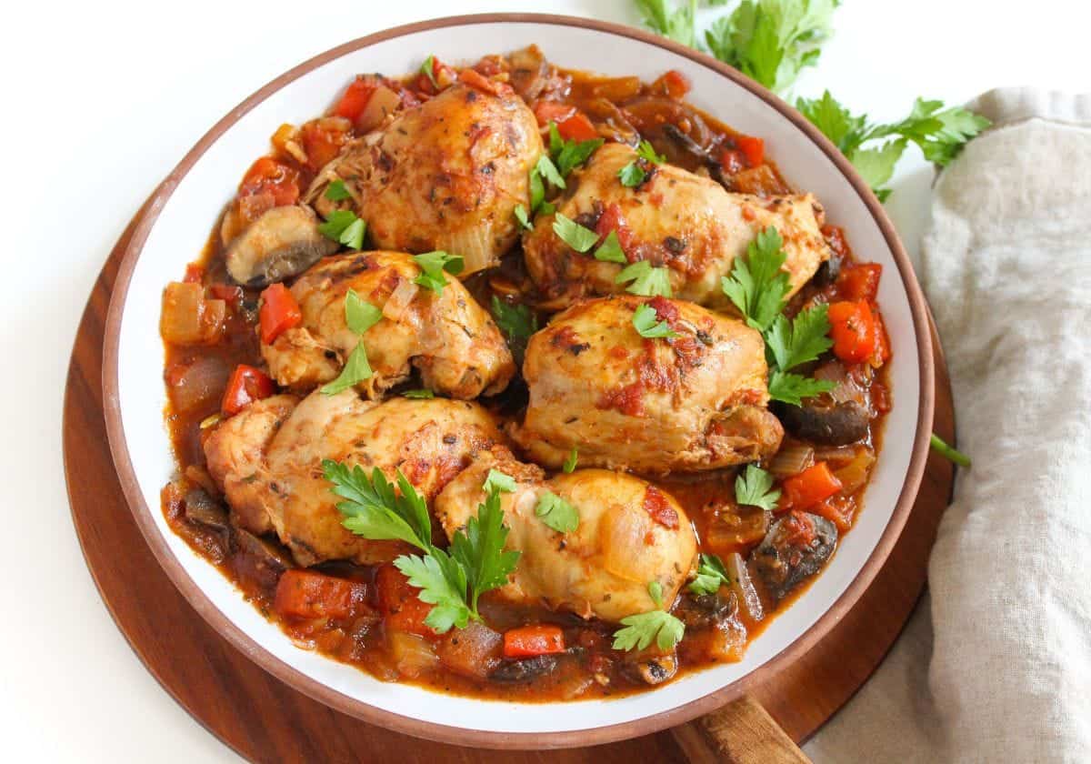 Chicken cacciatore on a white plate.