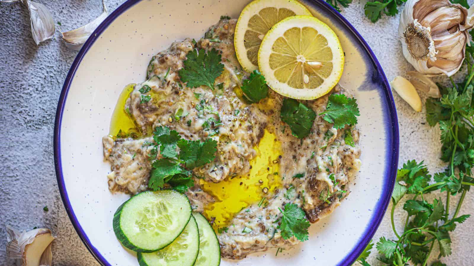 A plate of holiday appetizers - fish, cucumbers, and lemons.