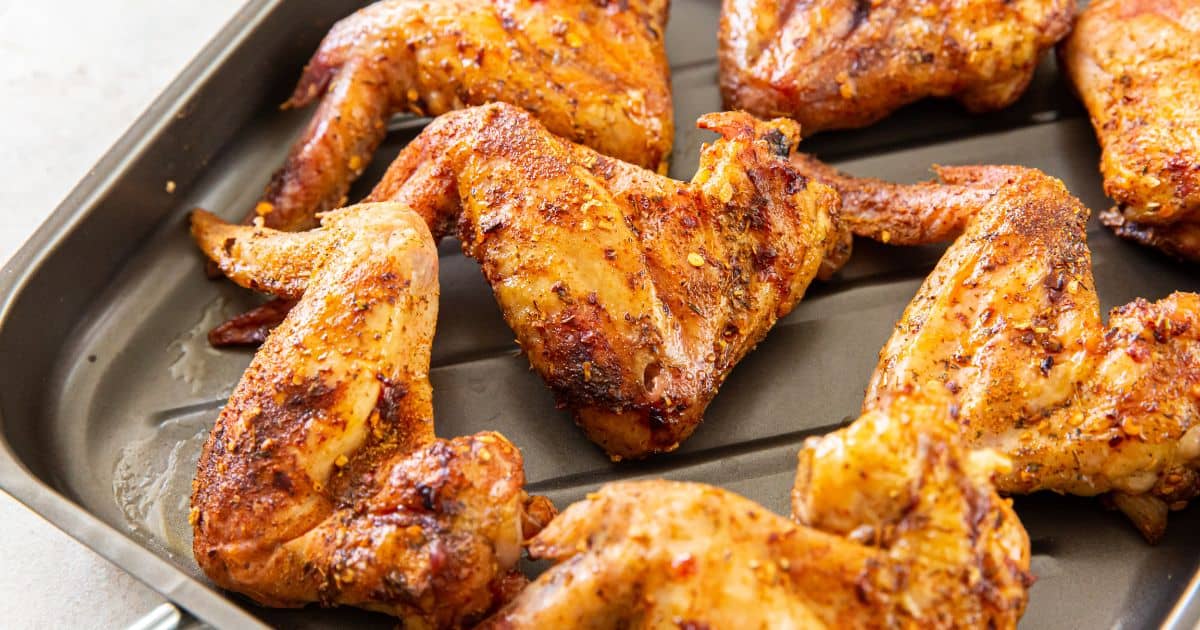 Smoked chicken wings on a baking sheet.