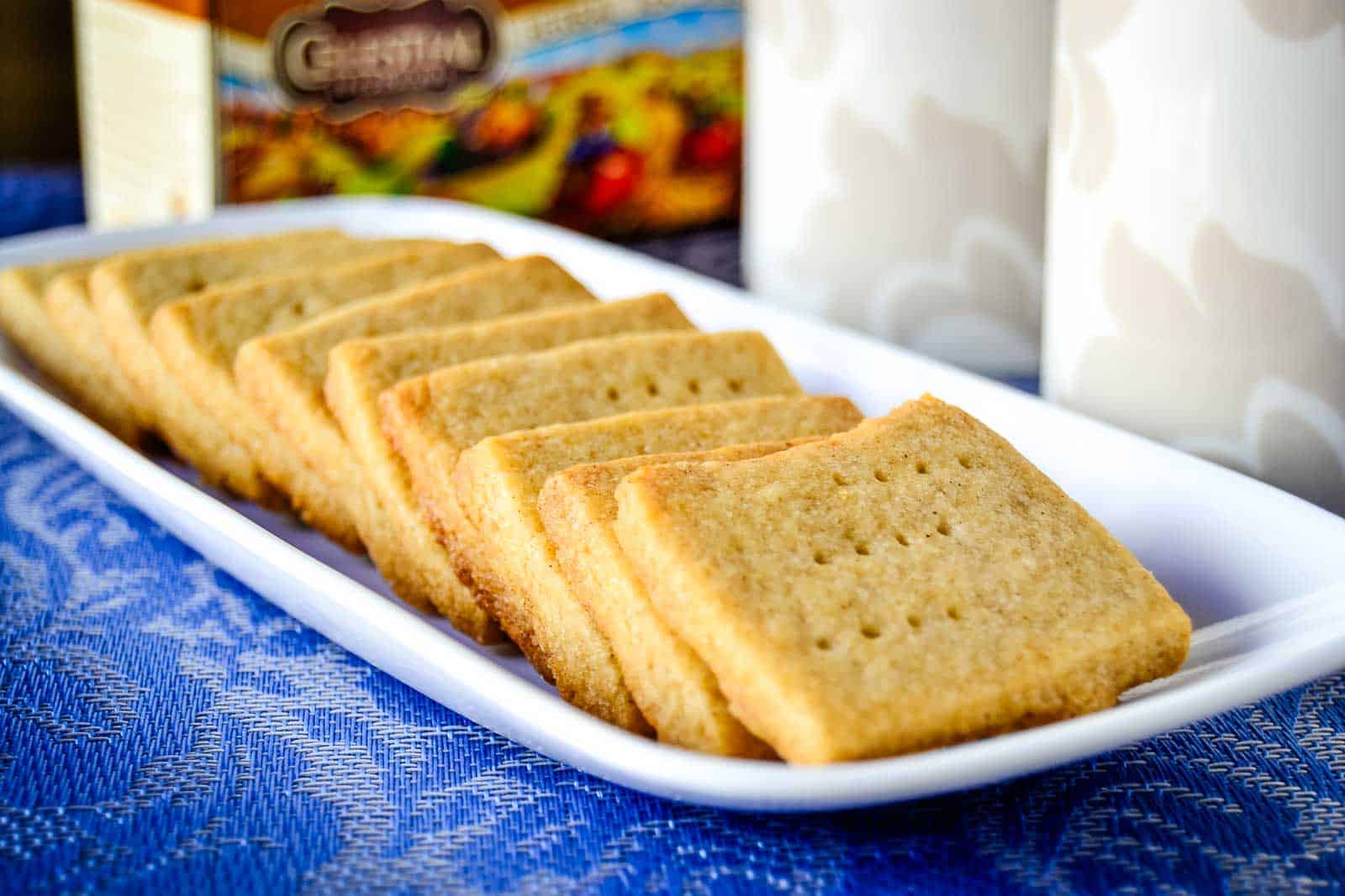 A white plate of a line of Spiced Shortbread Cookies lined up.