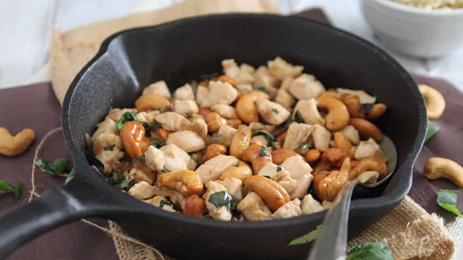 Thai basil cashew chicken in a cast iron skillet.