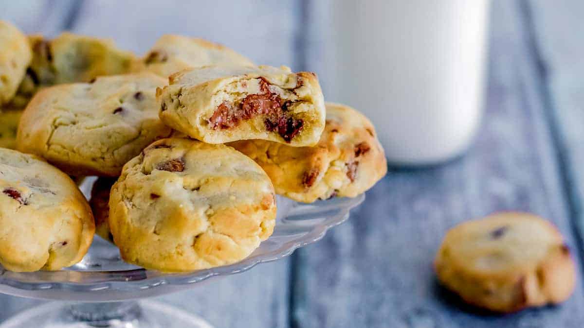 Air Fryer Chocolate Chip Cookies with milk in the background.