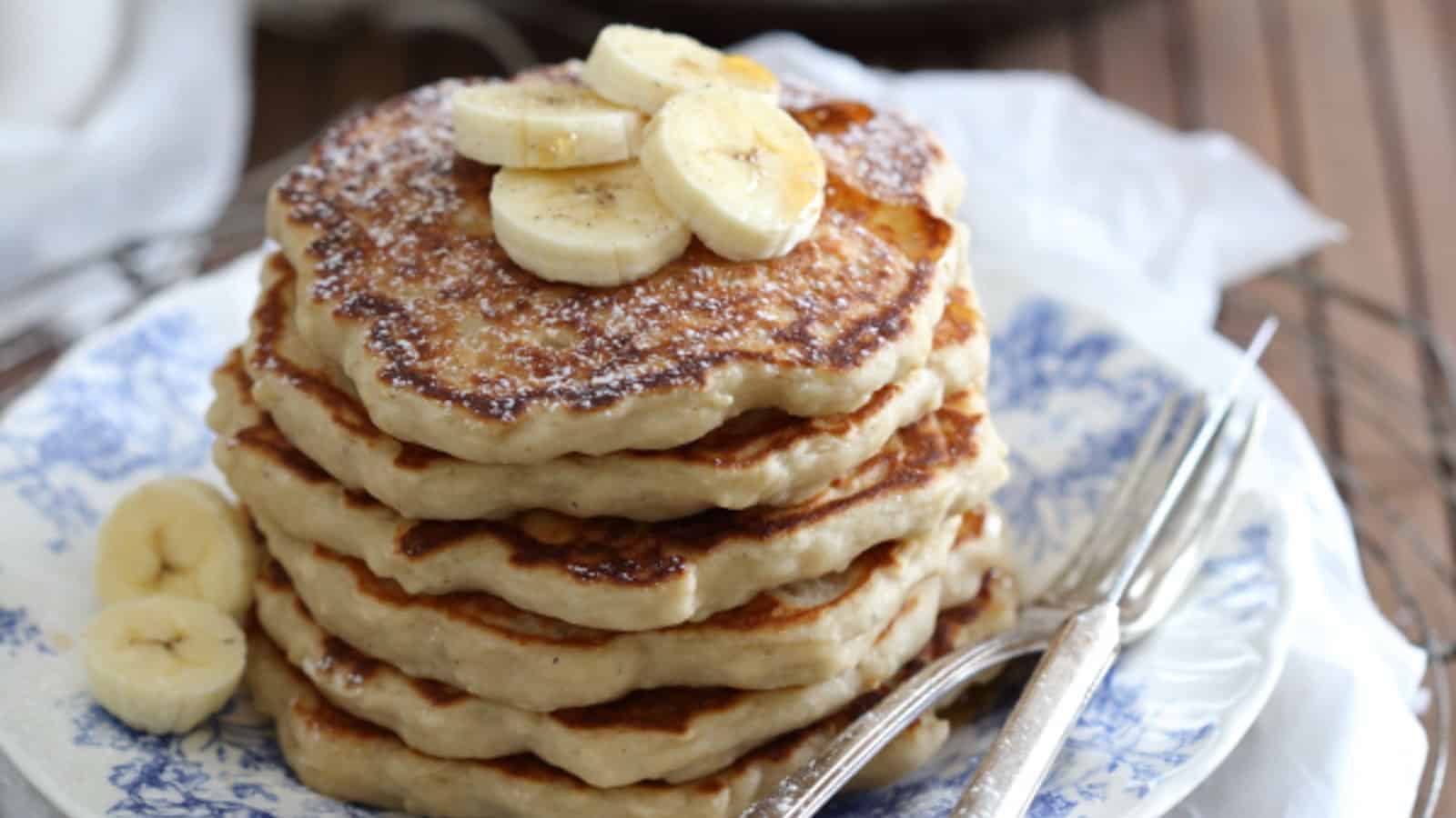 Yeasted banana nutmeg pancakes with banana slices on top.