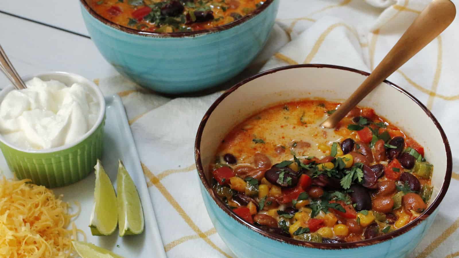 Corn and bean soup in a blue bowl.