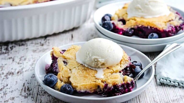 Blueberry cobbler topped with a scoop of vanilla ice cream.