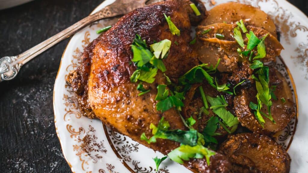 Easy roasted chicken with parsley and potatoes on a plate.