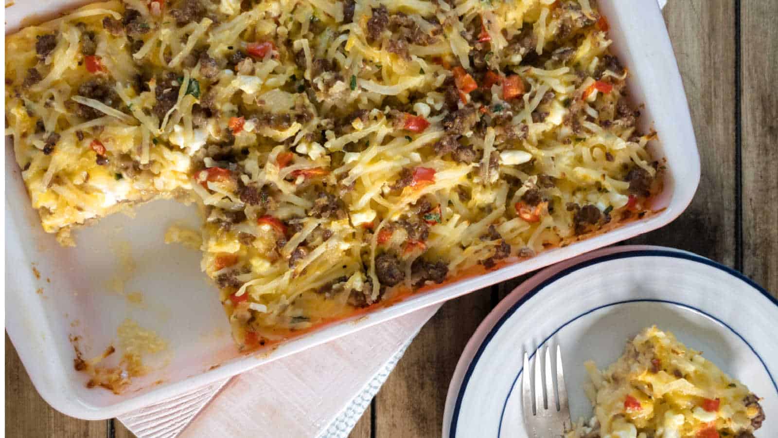 A hashbrown casserole in a white baking dish.