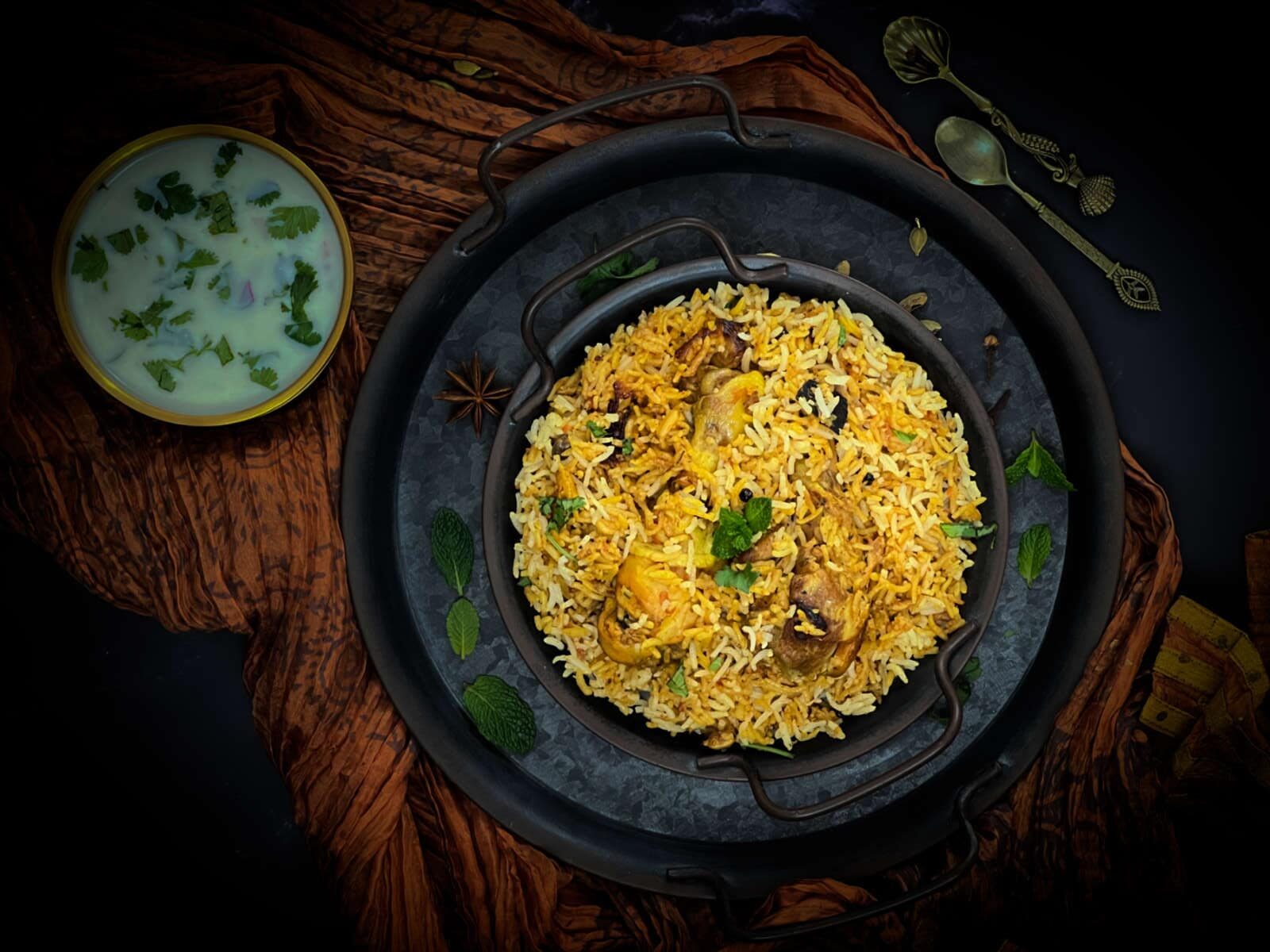 Chicken biryani placed on a black plate.