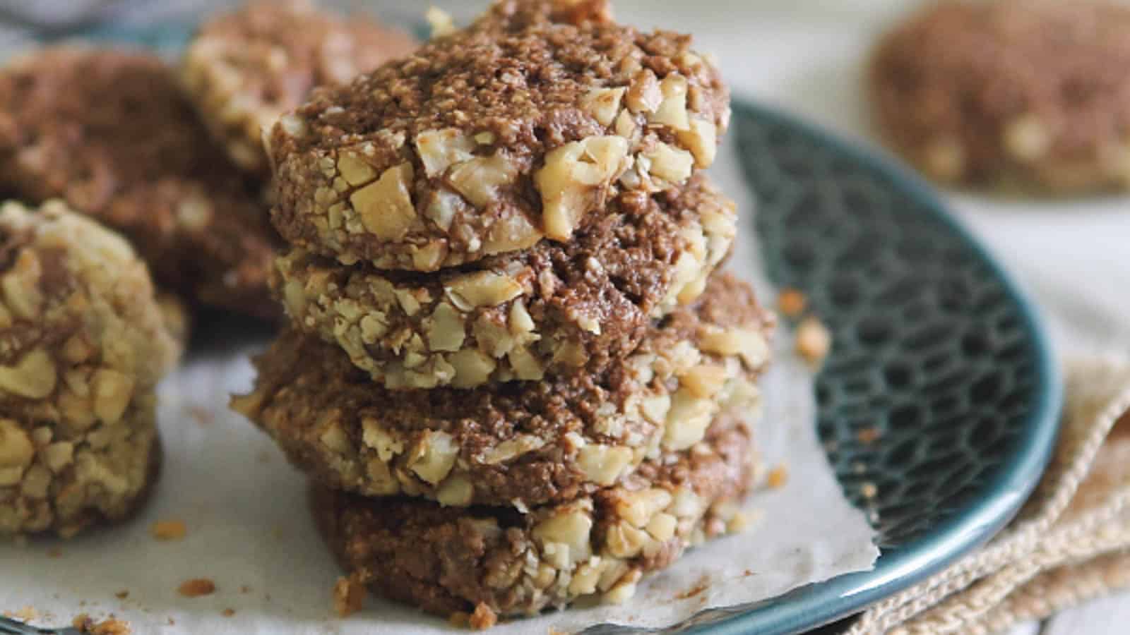 A stack of cookies on a plate with a napkin.