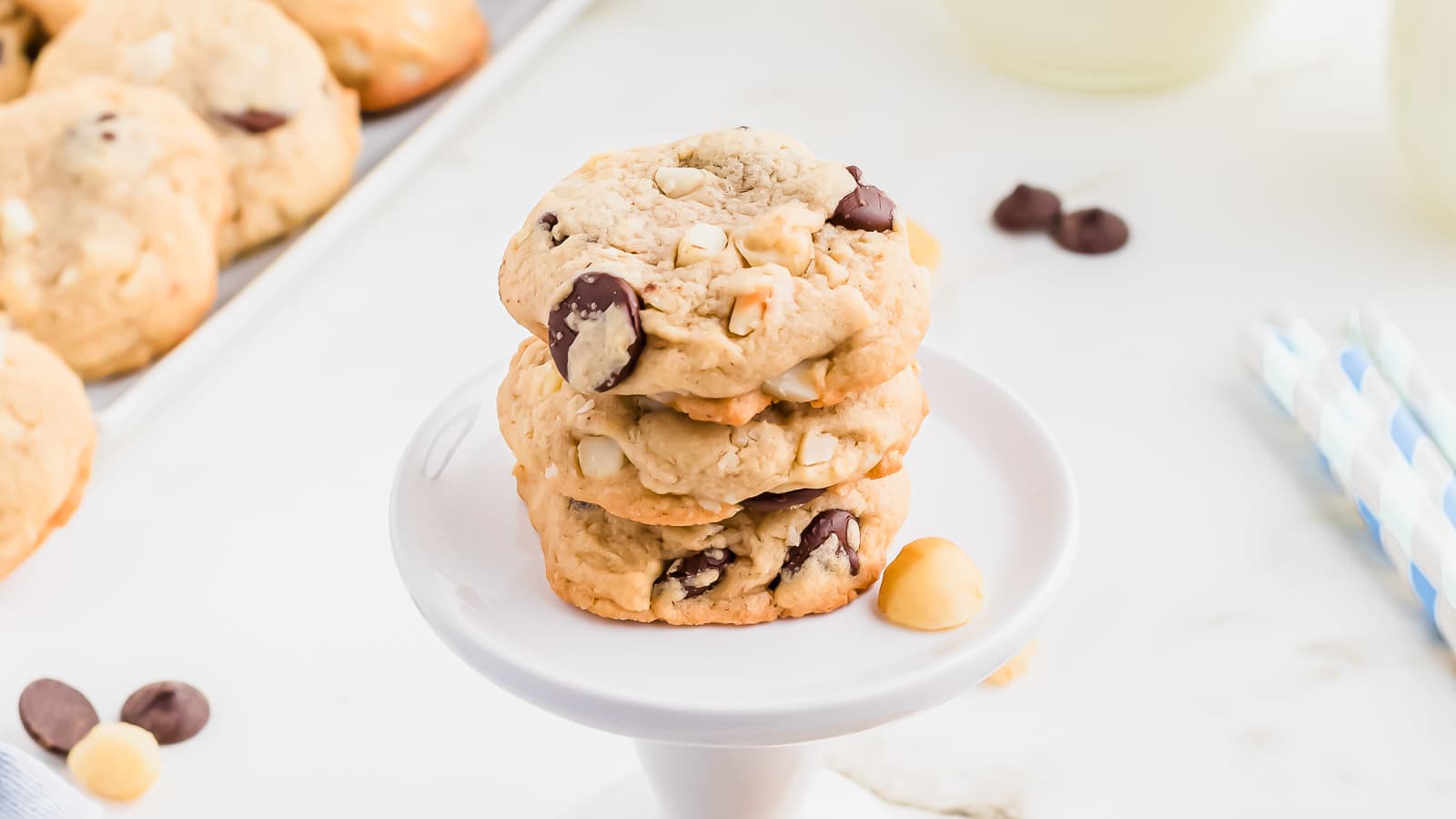 A stack of chocolate chip cookies on a white plate.