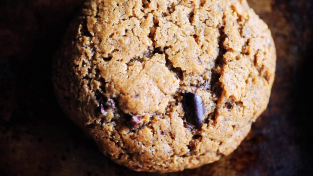 A close up of a gluten free cookie on a baking sheet.