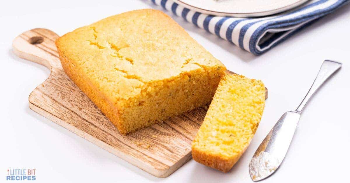 Sliced cornbread on a wood cutting board.