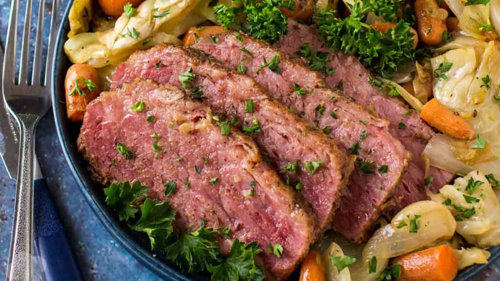 Corned beef and cabbage on a blue plate.