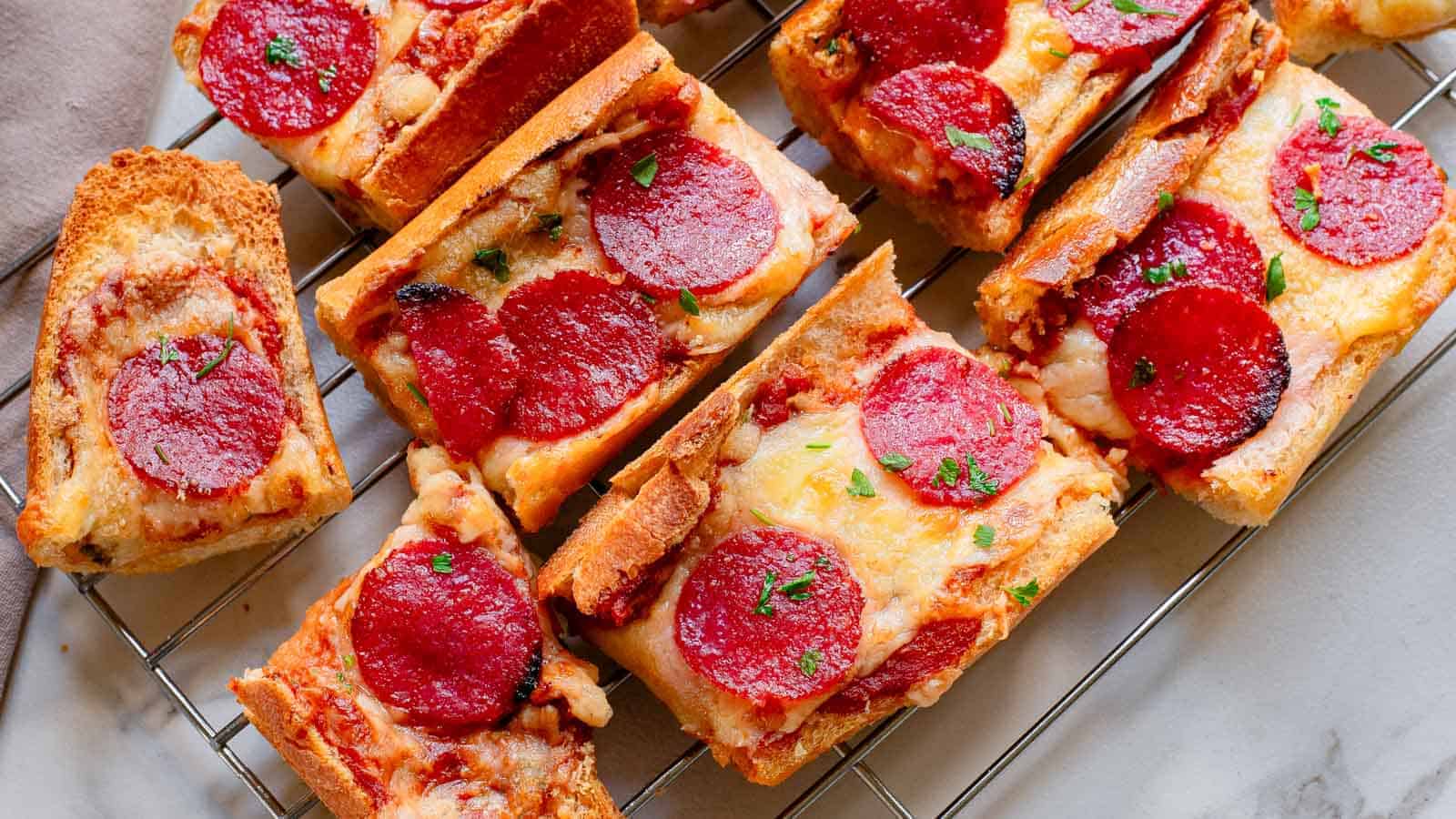 Pepperoni garlic pizza bread on a cooling rack.