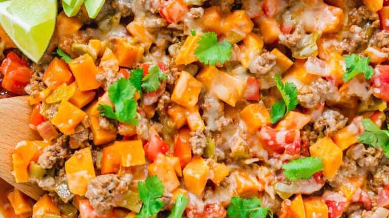 Mexican sweet potato casserole on a wooden cutting board.