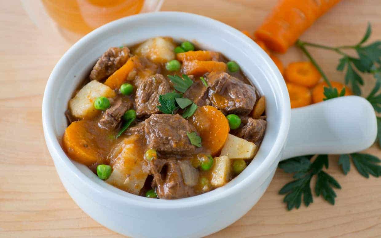 Bowl of Instant Pot beef stew with carrots and potatoes.