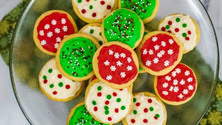 Christmas cookies on a plate with green, red and white icing.