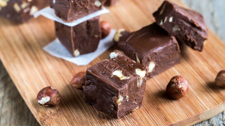 Chocolate hazelnut fudge on a wooden cutting board.