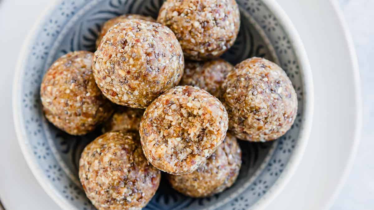 A bowl of energy bites on a plate.