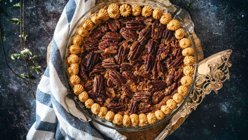 A pecan pie on a wooden board.