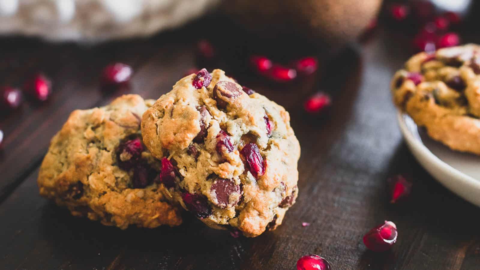 Pomegranate chocolate chip cookies on a wooden table.