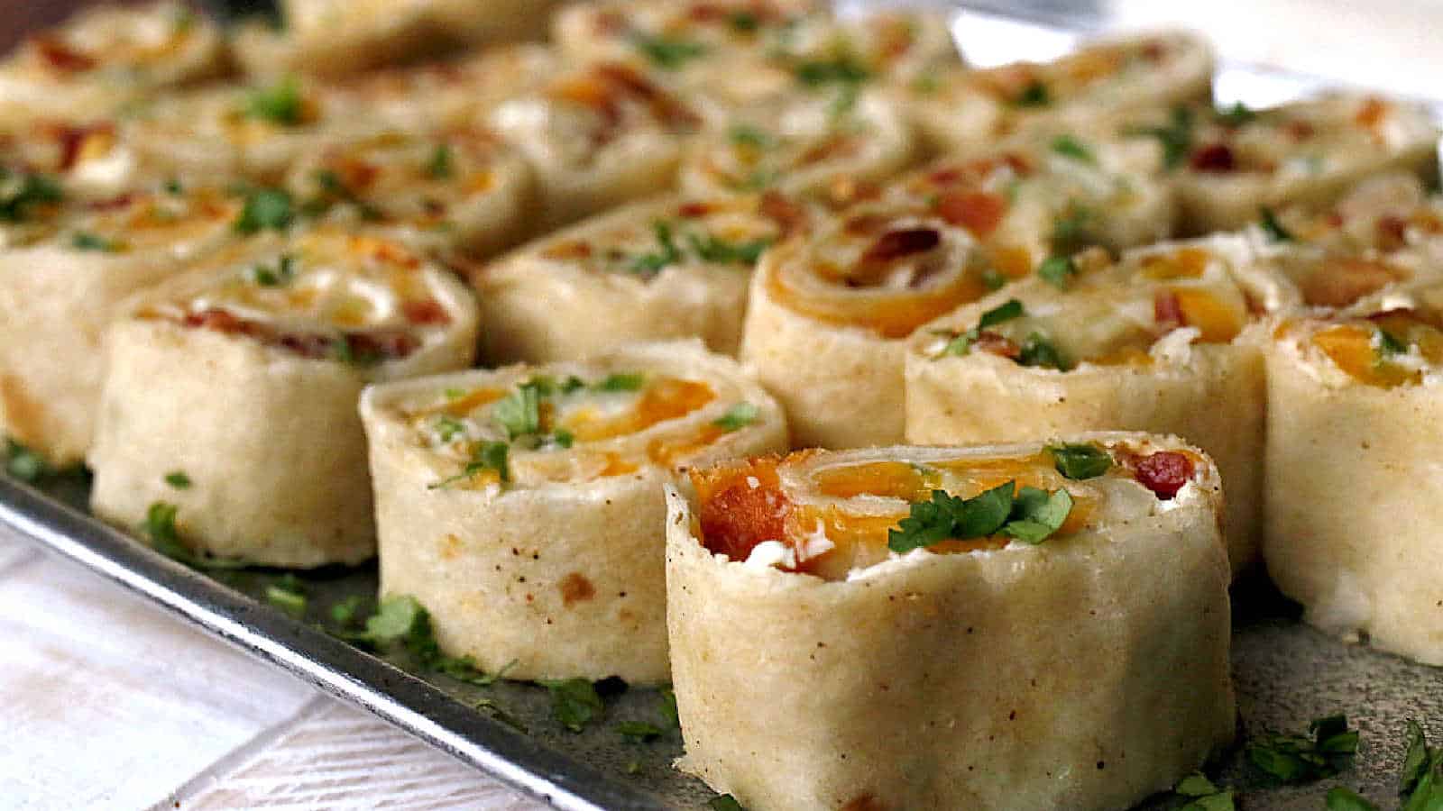 Jalapeno popper pinwheels on a silver tray.