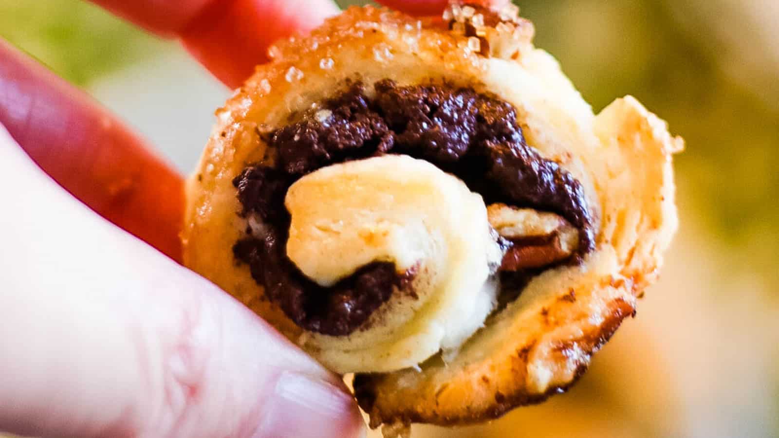 Low angle shot of rugelach cookies filled with chocolate and pecans.