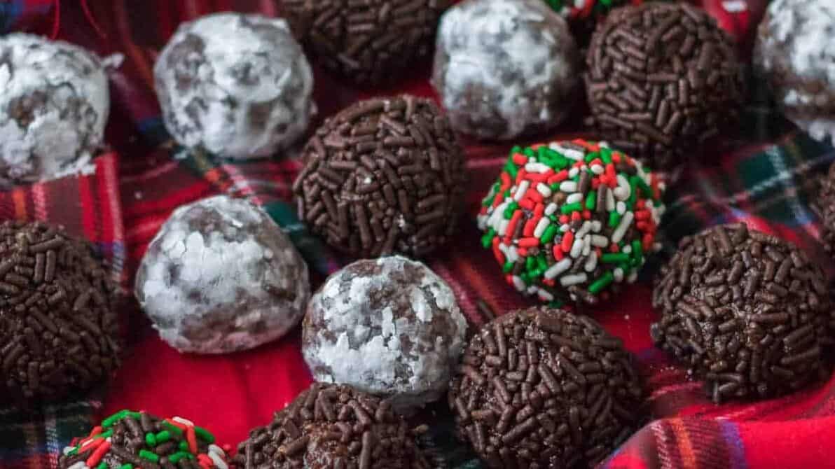 Chocolate rum balls on a plaid tablecloth.