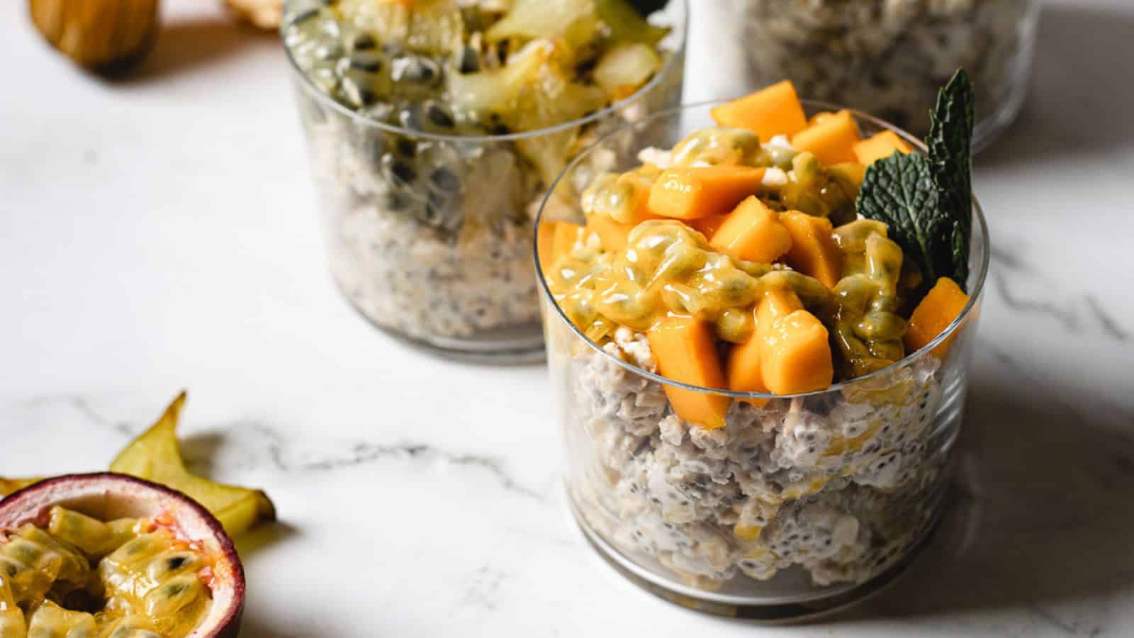 An easy breakfast of fruit and oats sitting on a marble table.