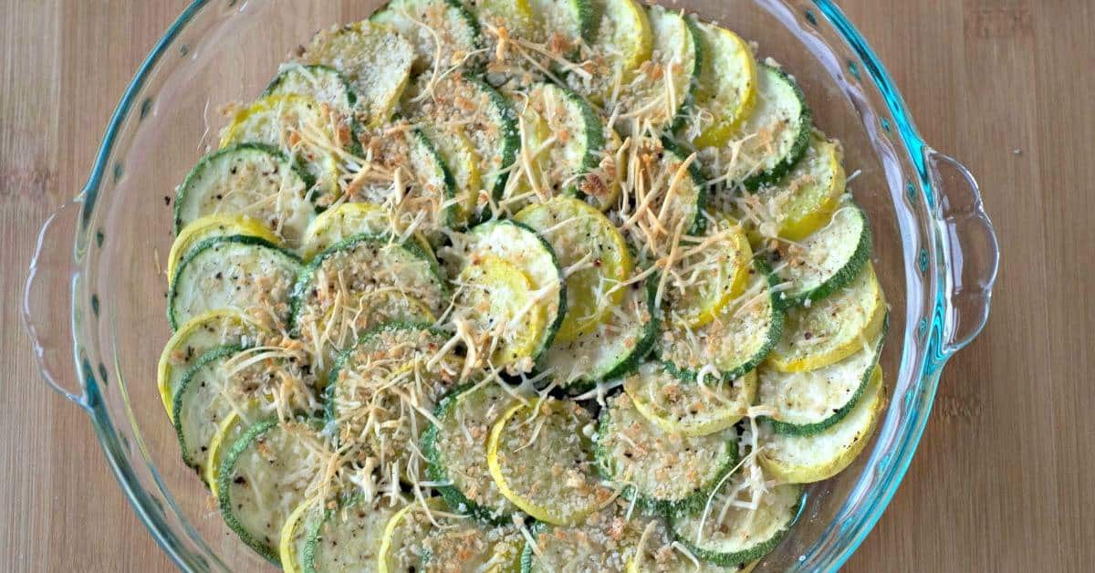 Zucchini and summer squash alternated in a dish topped with breadcrumbs.