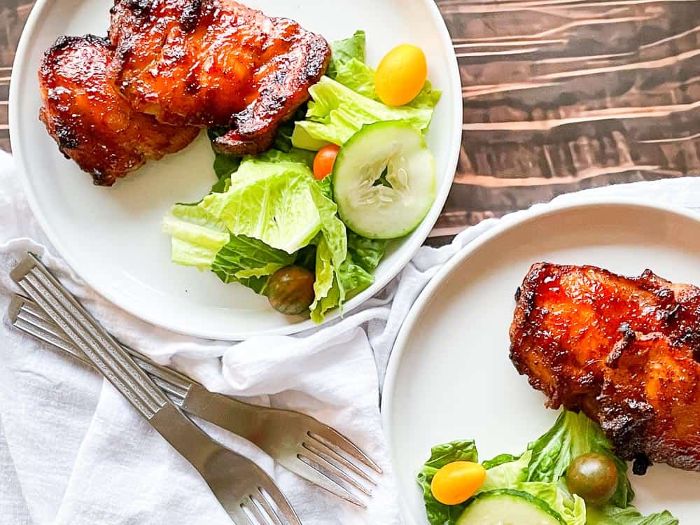 Serving trays with bbq chicken and salad.