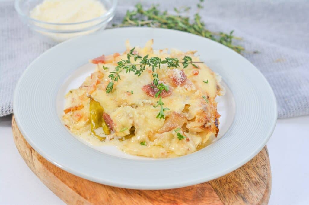 A white plate with a casserole on it.