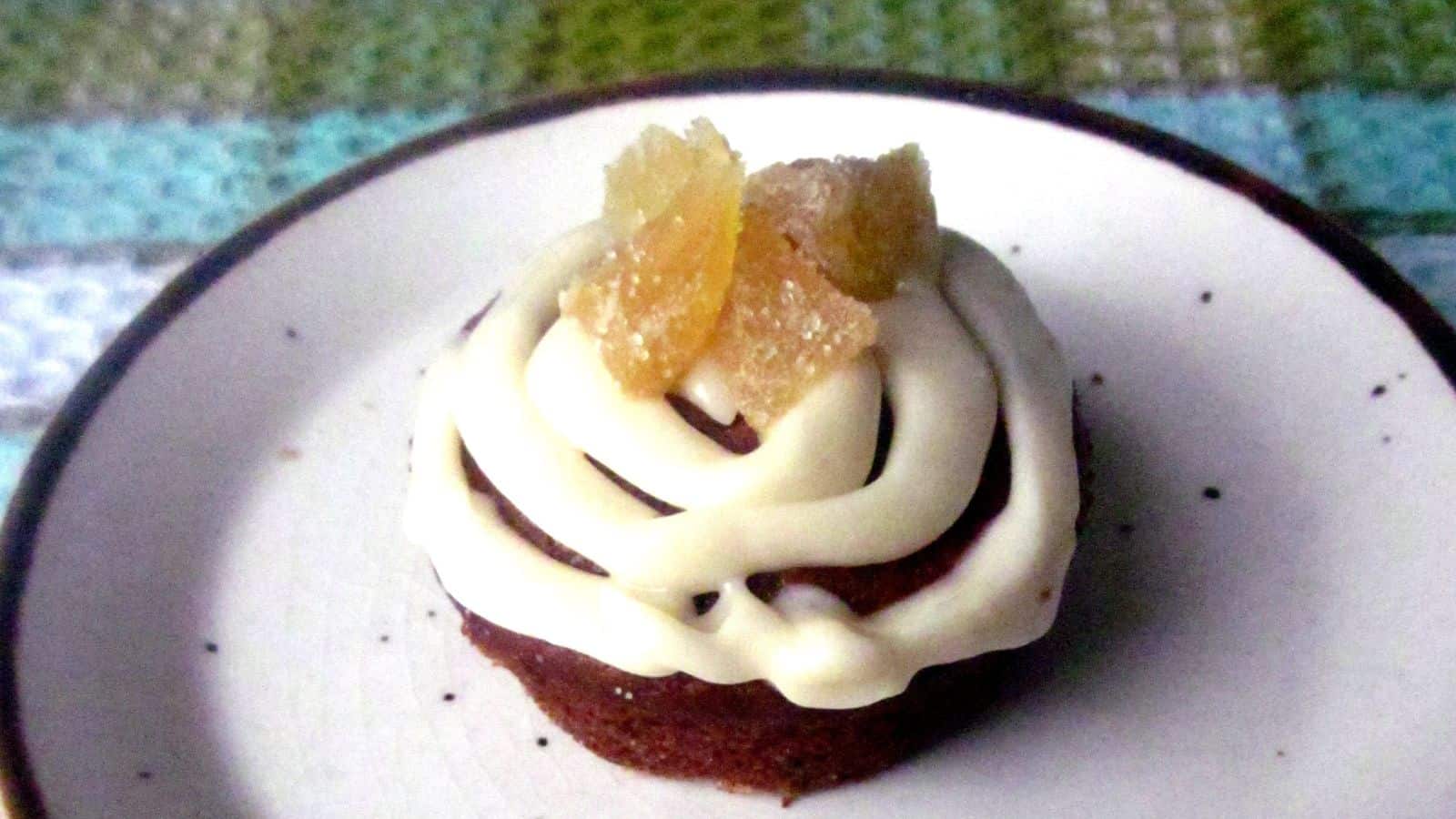 A delicious winter fruit cake with icing presented on a plate.